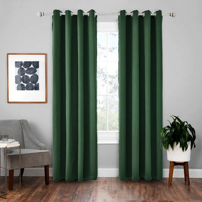 Light gray polyester blackout curtains with grommet tops hanging on a white rod in a modern living room.