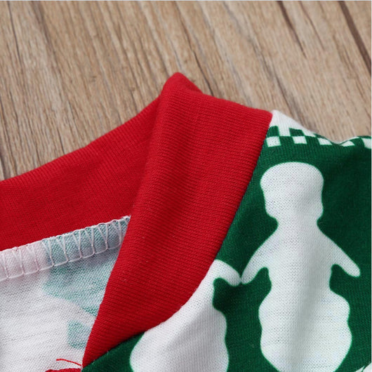 Family of four wearing matching red, green, and white Fair Isle Christmas pajamas, smiling together. - Image 3