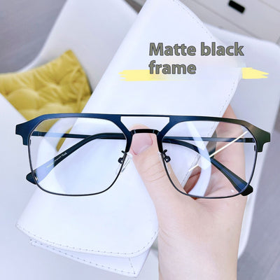 Anti-blue light glasses with a sand black and silver double beam frame, held against a white case. - Image 12