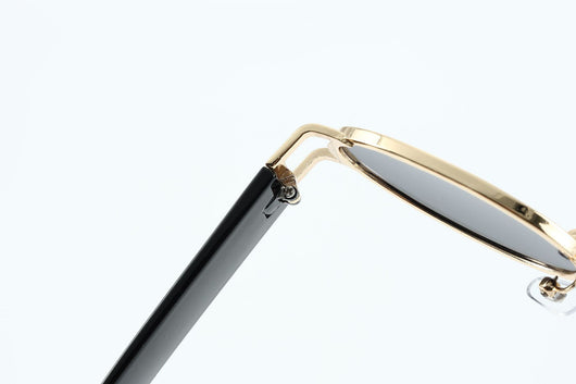 Retro small frame sunglasses with gold round frames and leopard print temples, held by a hand. - Image 13