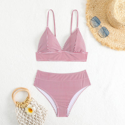 Green and white striped two-piece bikini with a triangle top and high-waisted bottoms on a woman. - Image 27