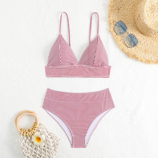 Green and white striped two-piece bikini with a triangle top and high-waisted bottoms on a woman. - Image 27