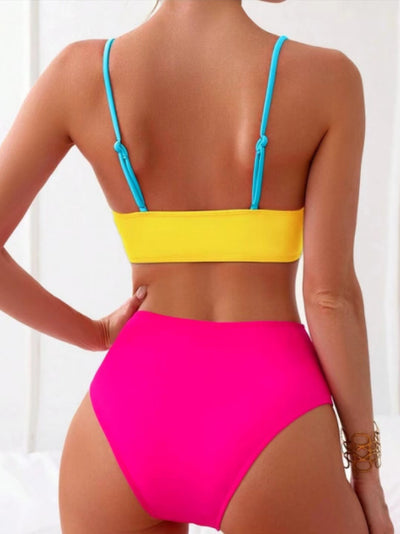 Woman wearing a blue color block split swimsuit with a wrapped front bikini top and high-waisted briefs. - Image 14