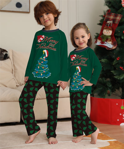 Family of four wearing matching green Christmas pajamas with "Merry Christmas" text and tree graphics. - Image 8