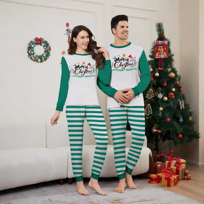 Family of four wearing matching green and white striped Christmas pajamas with "Merry Christmas" graphic. - Image 2