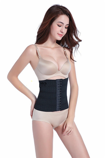 Woman modeling a beige waist trainer with hook-and-eye closures and a subtle floral pattern.