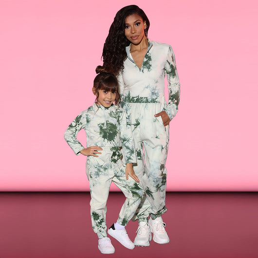 Mother and daughter wearing matching white, green, and blue tie-dye long-sleeved sweater and jogger sets.