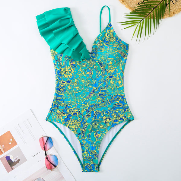 Women's one-shoulder ruffled swimsuit and matching sarong with blue and yellow lemon tile print.