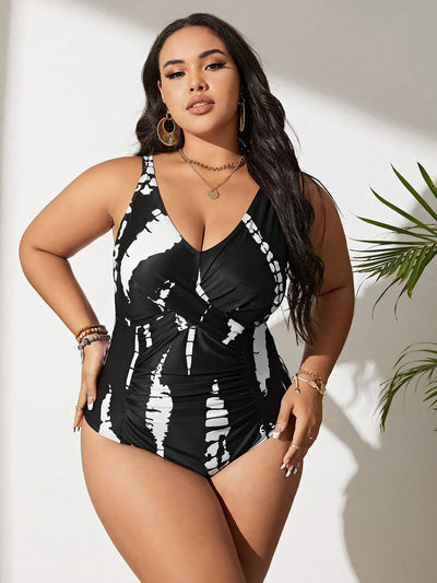 Plus size black and white tie-dye one-piece swimsuit with a V-neck and ruched detailing, worn by a model. - Image 13