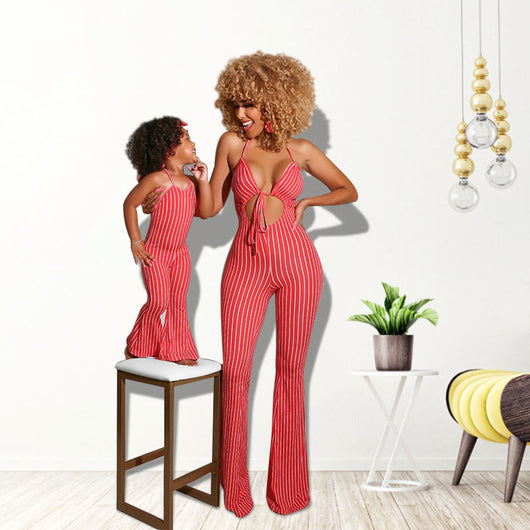 Mother and daughter in matching blue and white striped jumpsuits. Adult wears a halter neck cut-out jumpsuit, child wears a simple halter neck jumpsuit with a m - Image 8