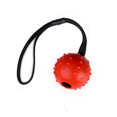 Red rubber dog training ball with nubs and a black rope handle, designed for bite resistance and molar cleaning. - Image 7