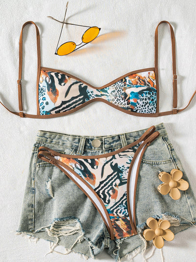 Black bandeau bikini swimsuit with thin straps and a gold-toned abstract ring detail on the top, paired with matching string bottoms. - Image 6