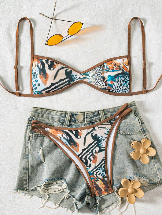 Black bandeau bikini swimsuit with thin straps and a gold-toned abstract ring detail on the top, paired with matching string bottoms. - Image 6