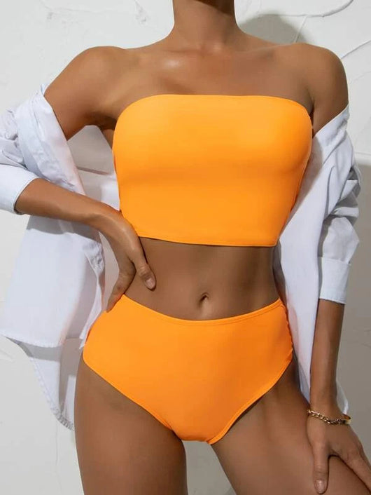 Vibrant orange strapless bandeau bikini top and high-waisted bottoms set, worn by a woman with a white shirt. - Image 12