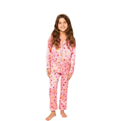 Young girl in a leopard print pajama set with black feather trim on the cuffs and ankles, wearing a pink glitter headband. - Image 5