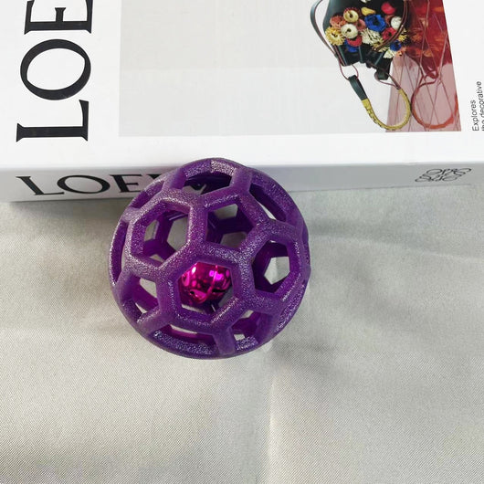 Orange TPR hollow lattice dog chew ball with a shiny pink bell ball inside for interactive pet play. - Image 6