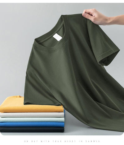 Light gray short-sleeve t-shirt with a round neck, held up to show its smooth fabric. A stack of folded t-shirts in various colors is visible in the background. - Image 27