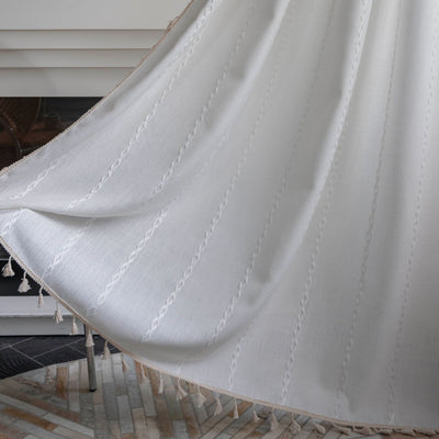 Black polyester curtain with white jacquard multi-line pattern and black tassels, draped over a white chair. - Image 27