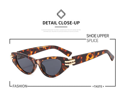 Black cat-eye sunglasses with dark gray lenses and gold-tone hinge accents on a white background. - Image 16