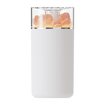 White portable aromatherapy humidifier with a clear top section displaying glowing pink salt crystals and a silver band. - Image 9