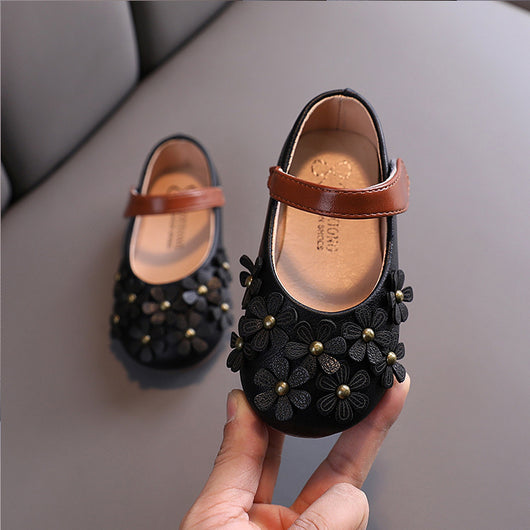 Black Mary Jane shoes for girls with 3D flower appliques on the toe and a brown hook-and-loop strap. - Image 11