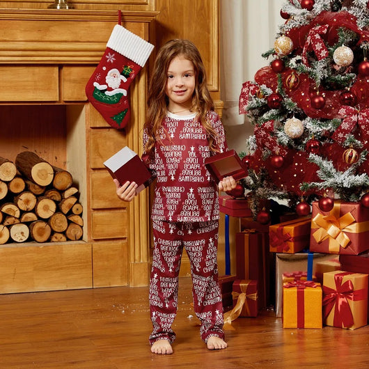 Family of four in matching Christmas pajamas: white tops with red tree graphic, red bottoms with white text. - Image 13