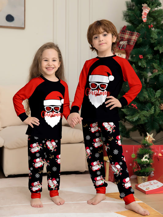 Woman wearing a black and red Christmas pajama set with a Santa Claus graphic top and snowman-patterned pants. - Image 2