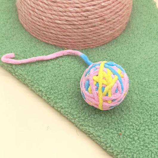 Colorful plush wool ball cat toys with long yarn tails, featuring various patterns and a bell inside for play. - Image 4