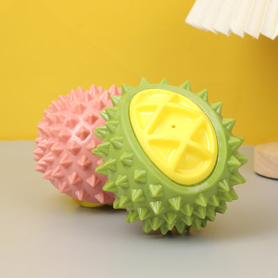 Pink and yellow durian-shaped chew toy with soft spikes, designed for pets, on a white display block. - Image 12