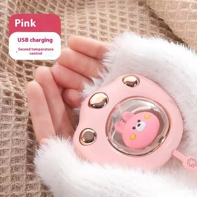 Dark green paw-shaped hand warmer and power bank with a cute bear design, held in a hand with white faux fur gloves. - Image 11