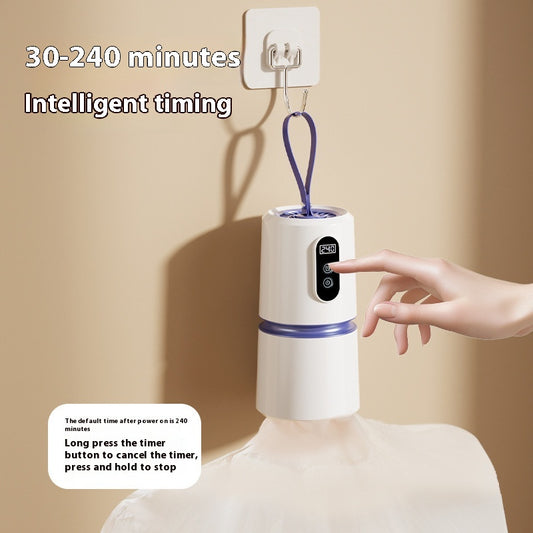 White and blue mini household air dryer with a digital display and hanging loop, shown next to a gold smartphone.