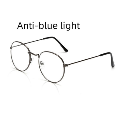Retro oval anti-blue light glasses with a dark metal frame and clear lenses on a white background. - Image 10