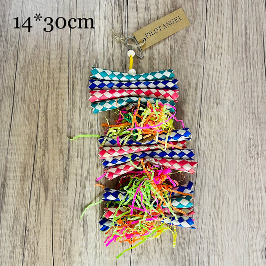Colorful parrot toy with woven blue, white, and red paper strips, filled with bright crinkly paper, on a wooden background. - Image 2