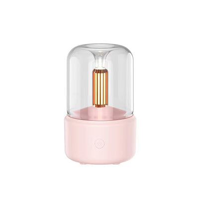White cylindrical aroma diffuser with a clear top and an amber candlelight-effect LED light. - Image 8