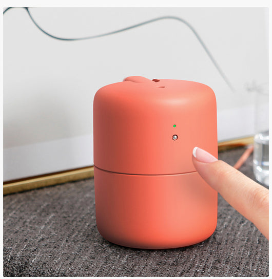 Coral desktop humidifier with a modern cylindrical design, featuring a green indicator light and a power button. - Image 10