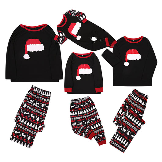 Family of four in black and red matching Christmas pajamas with Santa hat tops and fair isle pants. Also shown: a two-piece set and a baby romper. - Image 14