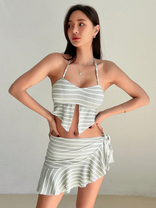 Woman in a light green and white striped two-piece swimsuit with a halter top and V-cut front hem. - Image 12