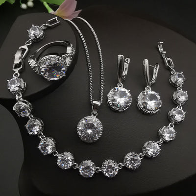 Four-piece silver-tone jewelry set with round green gemstones, including a necklace, bracelet, ring, and dangle earrings. - Image 3