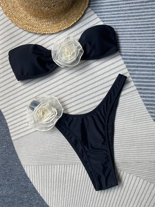 Black tube top bikini with white three-dimensional flower embellishments, worn by a woman partially submerged in water. - Image 16