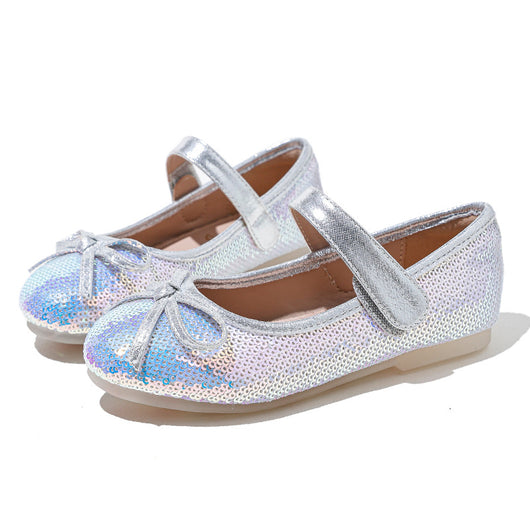 Silver sequined princess shoes for big kids with a soft sole, featuring a decorative bow and a Mary Jane strap.