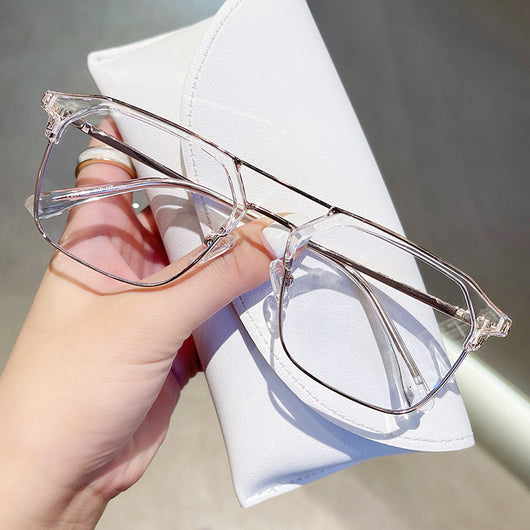 Anti-blue light glasses with a sand black and silver double beam frame, held against a white case. - Image 2
