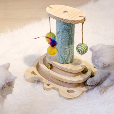 White cat playing with a wooden multi-level track toy featuring a spring-mounted yellow feather ball and a green catnip ball. - Image 5