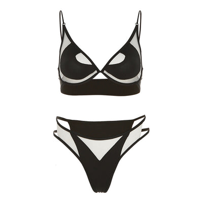 Woman wearing a white two-piece bikini with a bralette top featuring sheer cut-outs and a high-cut thong bottom with multiple straps. - Image 3