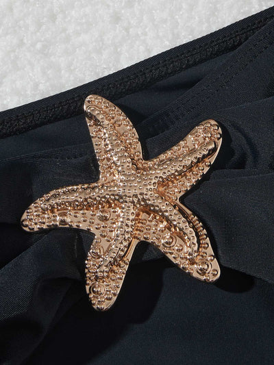 Black three-piece bikini set with triangle top, thong bottom, and skirt, all featuring gold starfish embellishments. - Image 16