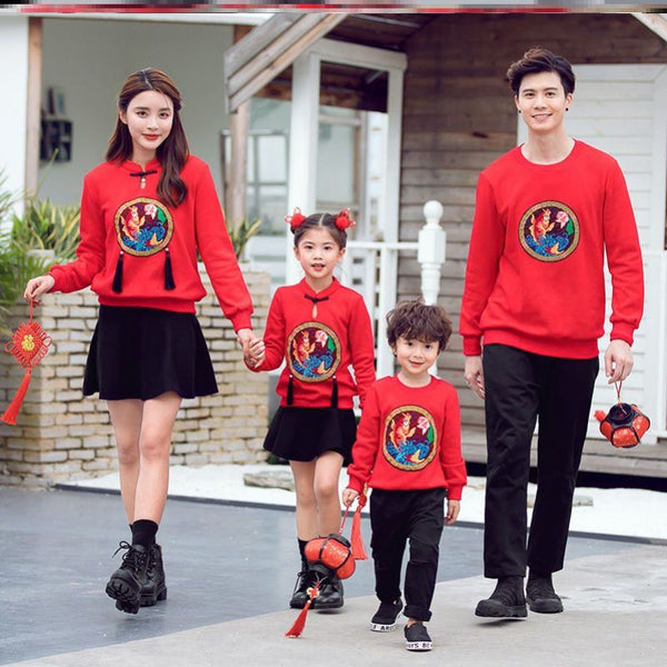 Family of four in matching red long-sleeve tops with a rabbit graphic, celebrating the Year of the Rabbit. - Image 4