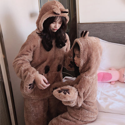 Mother and child wearing matching brown plush bear pajamas with hoods, ears, and embroidered paw gloves. - Image 4