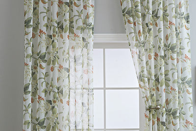 Dark gray semi-sheer curtains with a white and green floral pattern, hung on a black rod in a living room. - Image 24