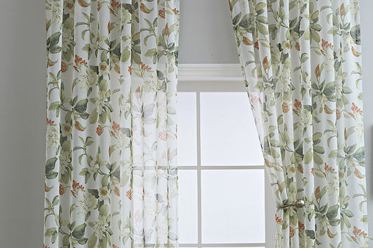 Dark gray semi-sheer curtains with a white and green floral pattern, hung on a black rod in a living room. - Image 24