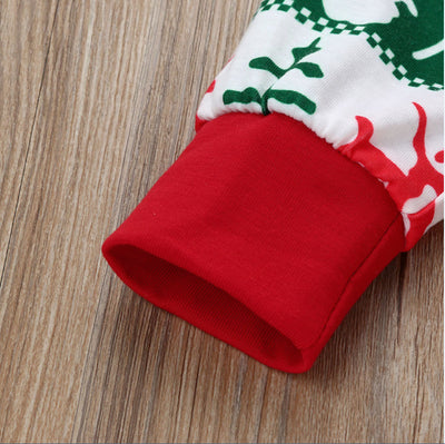 Family of four wearing matching red, green, and white Fair Isle Christmas pajamas, smiling together. - Image 4