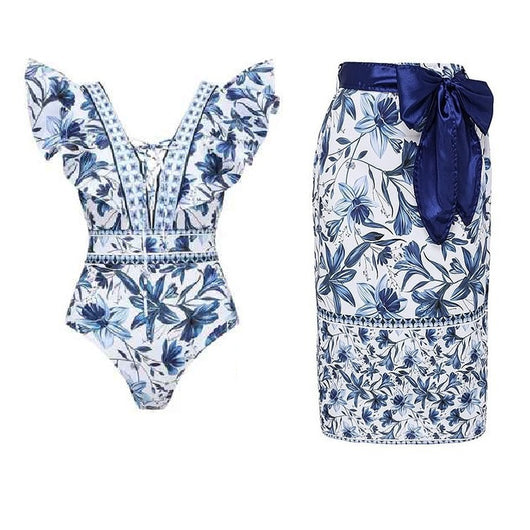 Women's blue and white floral one-piece swimsuit with ruffled V-neck and matching sarong skirt with bow. - Image 7